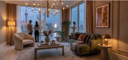 Evening living room with sculptural furniture and city views